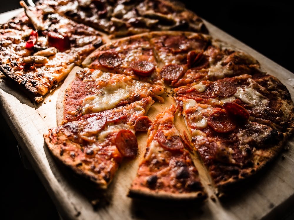 Image by Brett Jordan at https://www.pexels.com/photo/pizza-on-brown-wooden-board-825661/