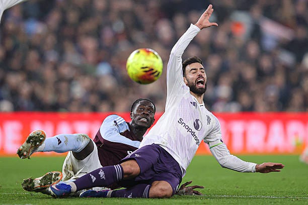 Bruno Fernandes of Manchester United is fouled by Amadou Onana of Aston Villa resulting in an injury during the Premier League match between Aston...