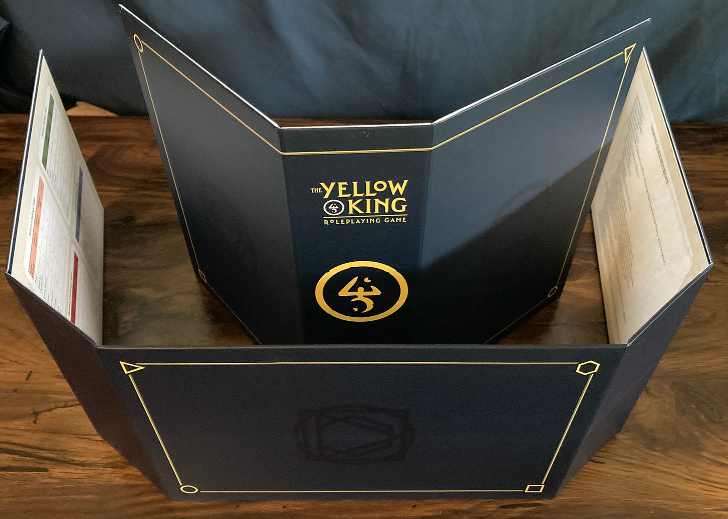 The Yellow King RPG GM screen, which folds together to create a slipcase.