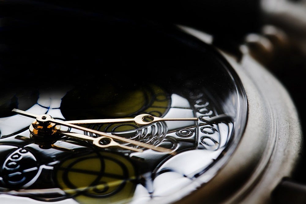 A close up of a clock in shadow.