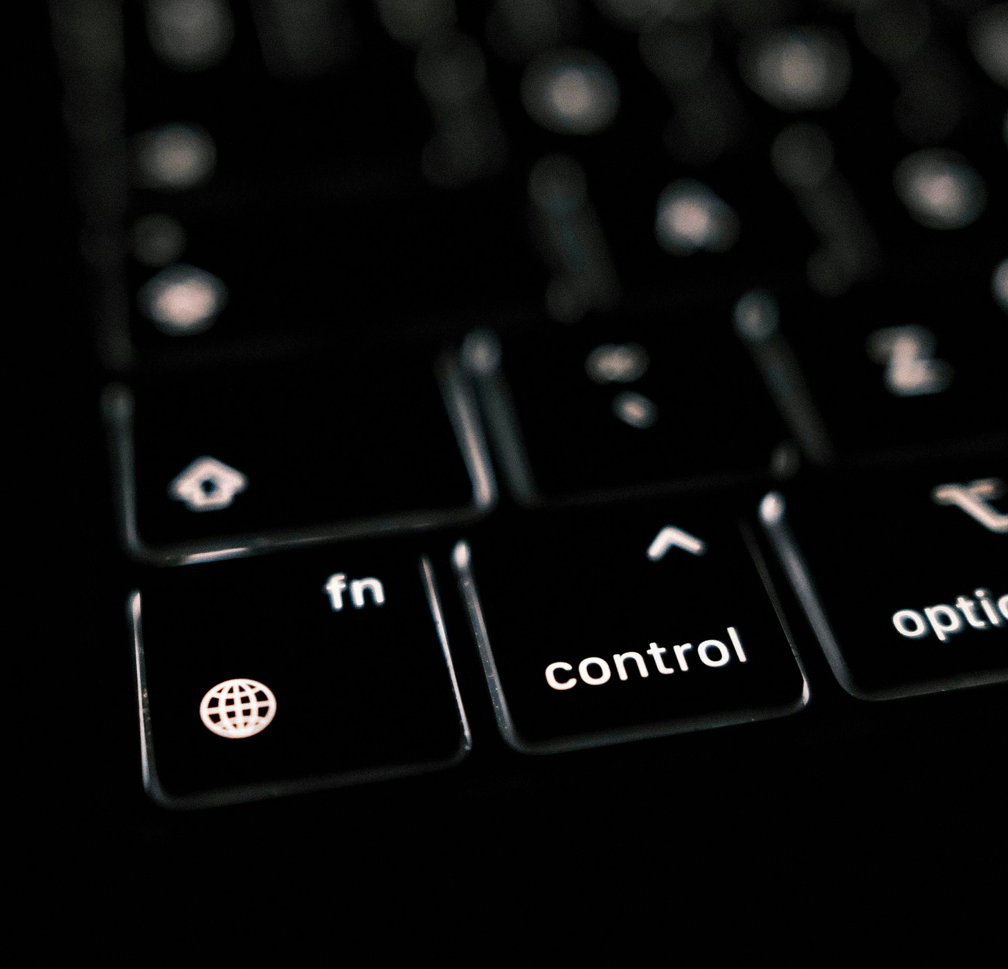 a close up of a black keyboard with white keys