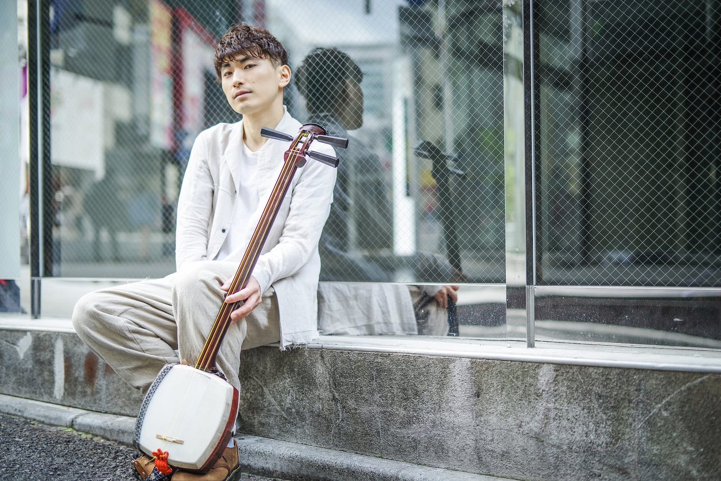 A man holding a shamisen.