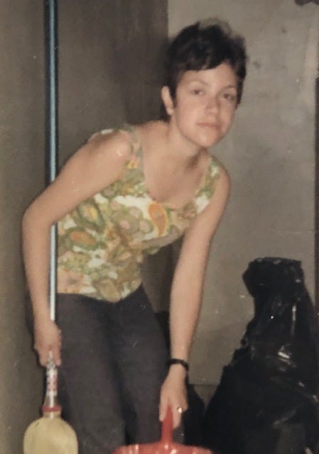 Young woman sweeping floor