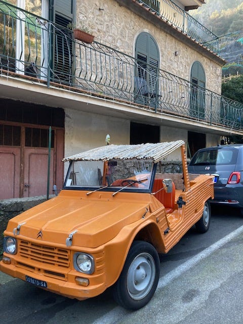 Two orange Citroen Mehari cars, one in Amalfi and the other a model on my desk.