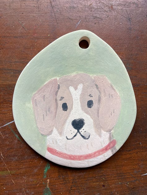Three ornaments with dog portraits on them