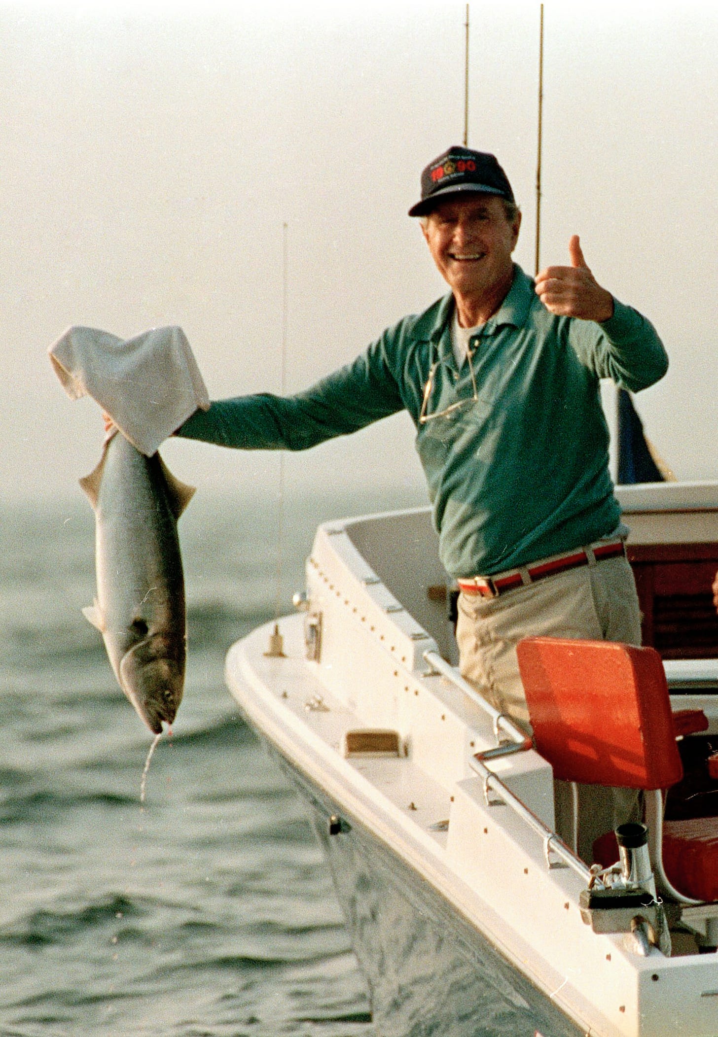 President George H.W. Bush gives a thumbs up, proudly holding a 12-15 pound blue fish caught near his Kennebunkport, Maine, vacation home, August 16, 1991. President George H.W. Bush gives a thumbs up, proudly holding a 12-15 pound blue fish caught near his Kennebunkport, Maine, vacation home, August 16, 1991.