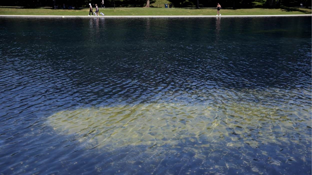A body of water with people walking
AI-generated content may be incorrect.