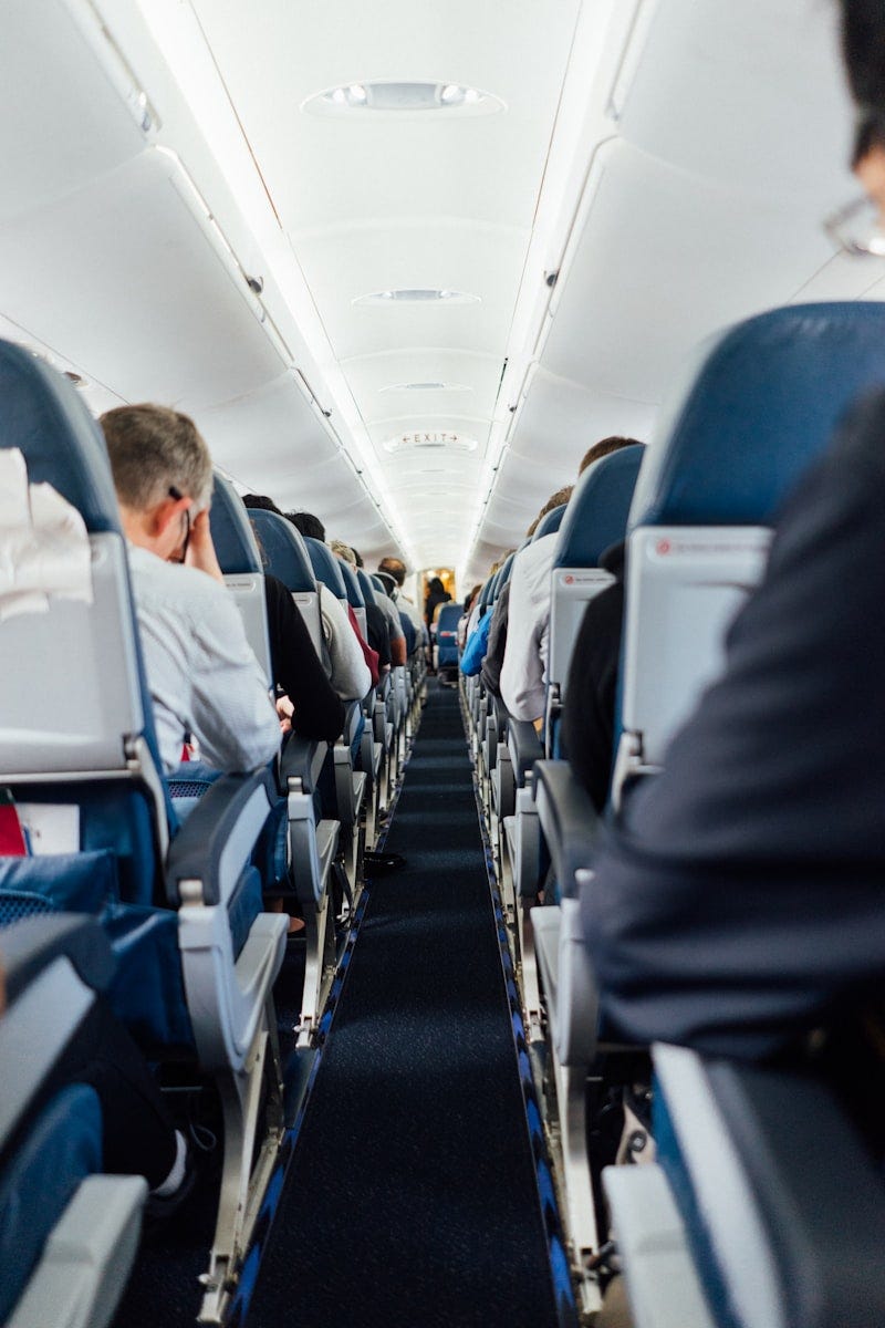Luxury business class aircraft cabin with wide seats and ambient lighting Luxury business class aircraft cabin with wide seats and ambient lighting
