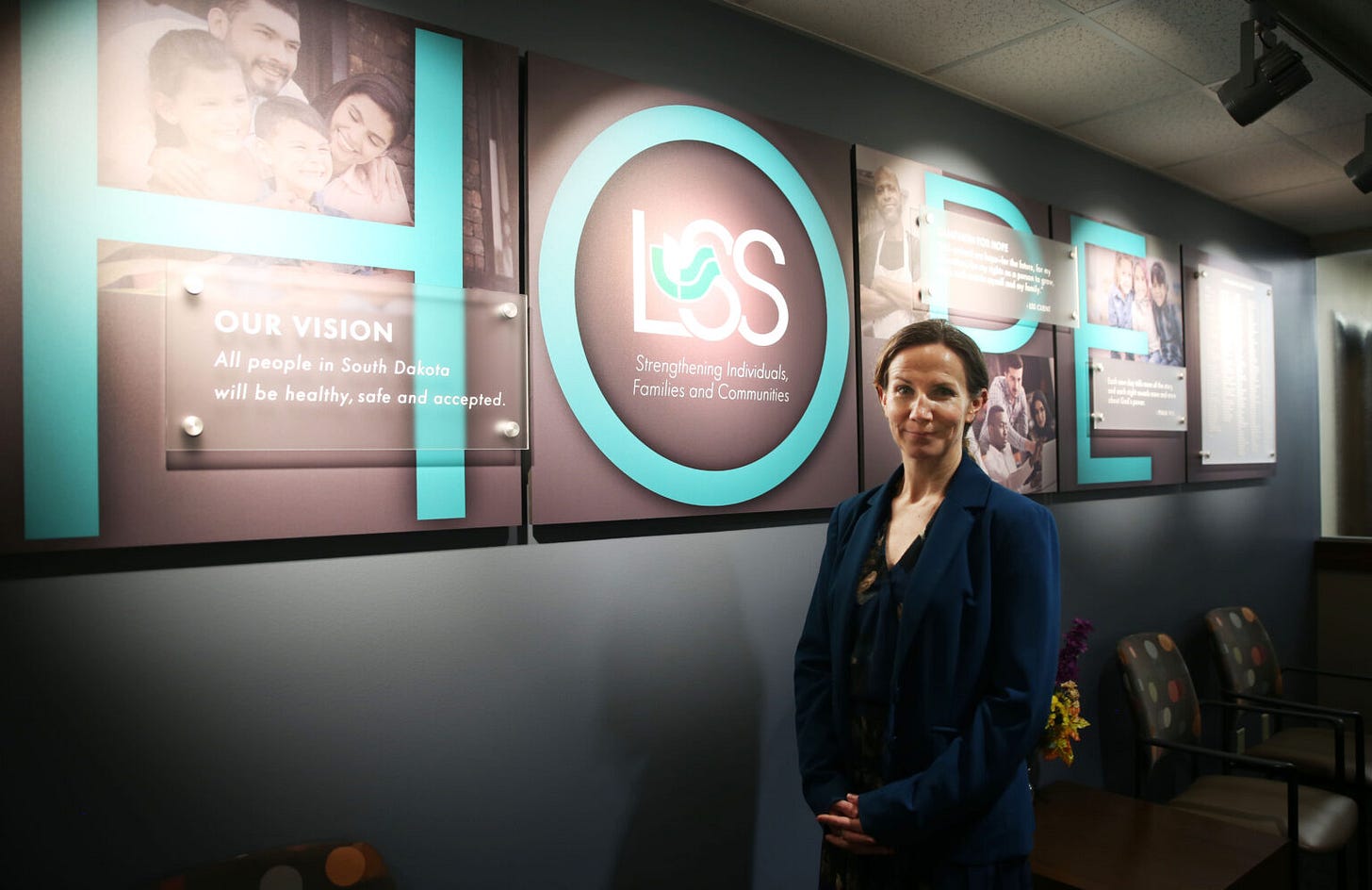 Lutheran Social Services State Refugee Coordinator Dana Boraas poses for a photo in June 2025 in the LSS Center for New Americans lobby. (Makenzie Huber/South Dakota Searchlight)