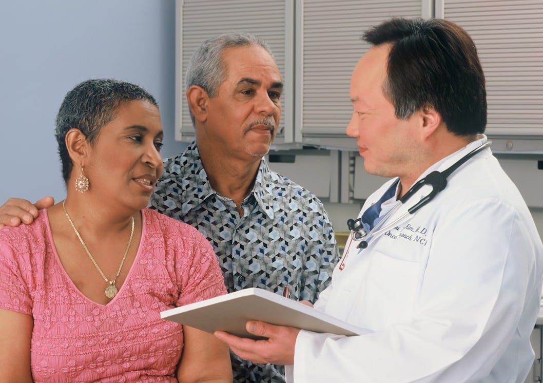 man in white button up shirt holding white tablet computer