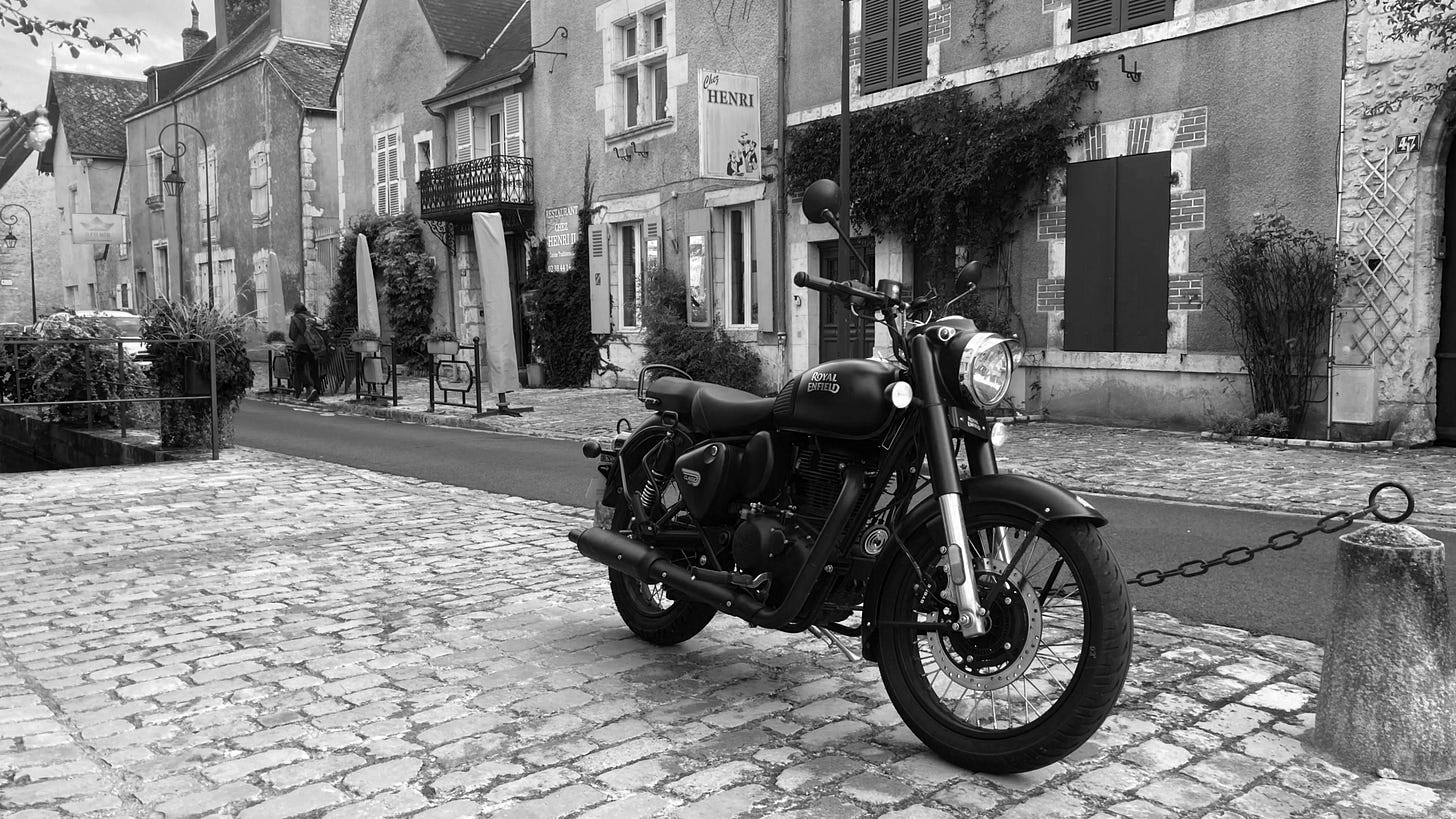 Royal Enfield motorcycle in an old French town. Royal Enfield motorcycle in an old French town.