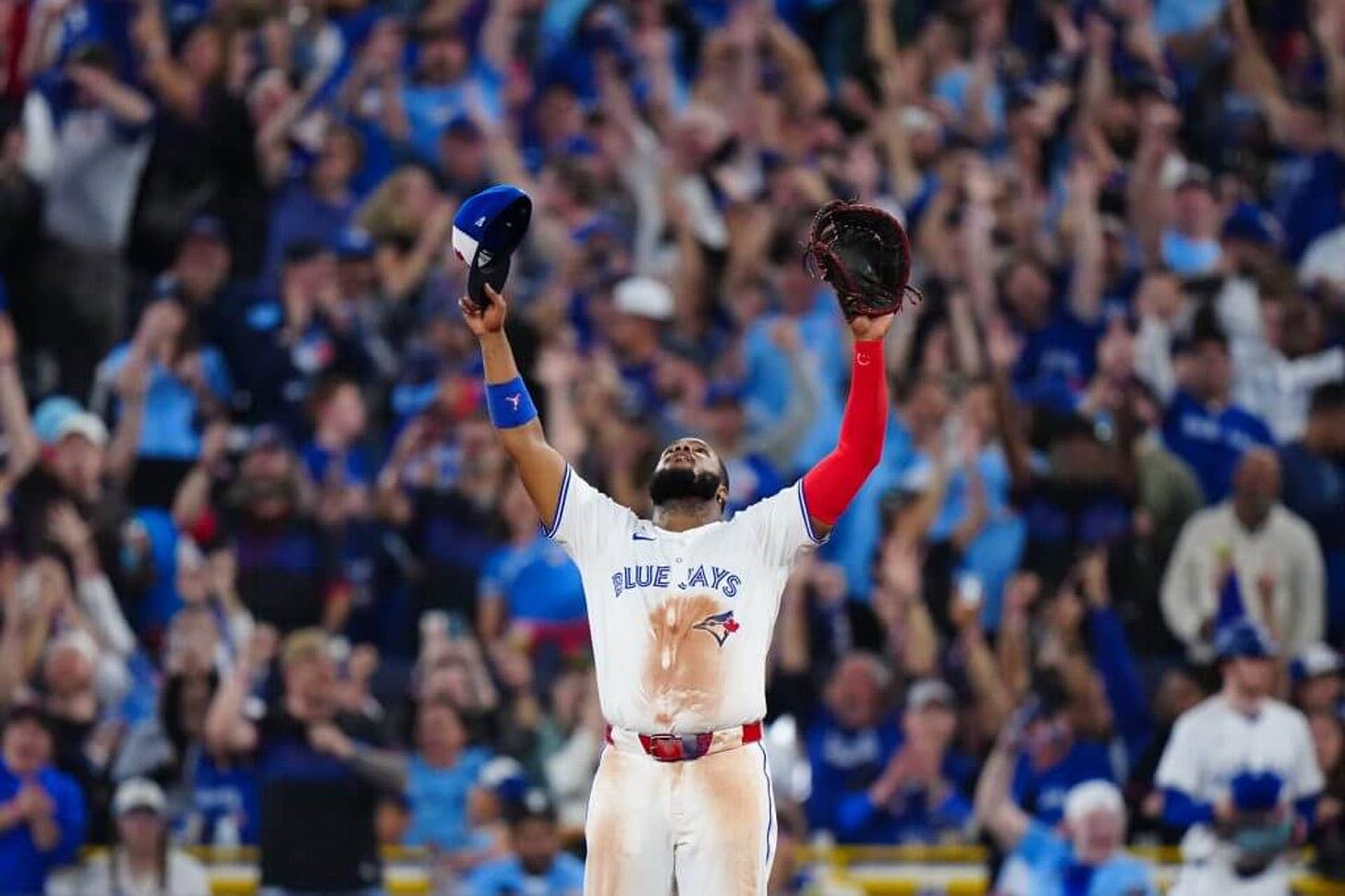 Vladimir Guerrero Jr. lifts his arms toward the sky as fans at the Rogers Centre cheer following the Blue Jays' win over the Mariners on Sunday night.