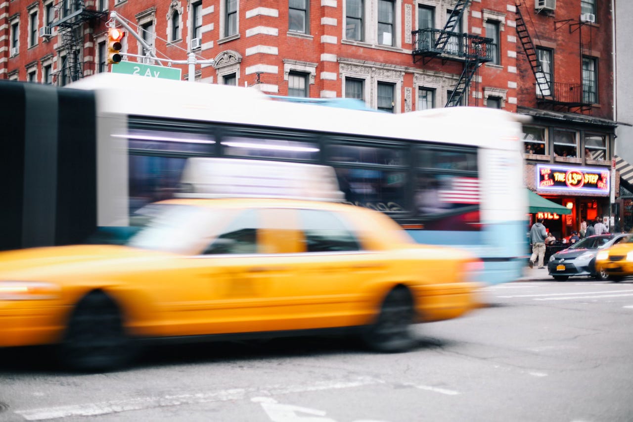 A blurry yellow taxi cab.