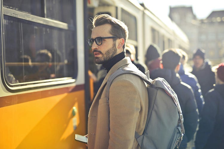 Man standing beside train. Man standing beside train.