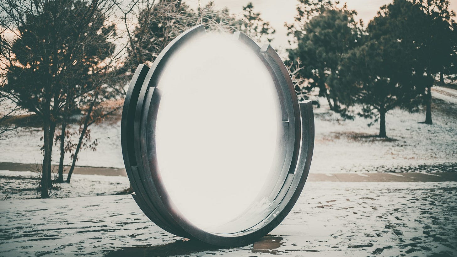 A portal like object is seen in the foreground, with scattered trees on a greyed, almost black and white, snowy slope in the background A portal like object is seen in the foreground, with scattered trees on a greyed, almost black and white, snowy slope in the background
