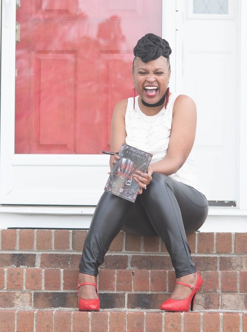 AJ Shirley beaming with book