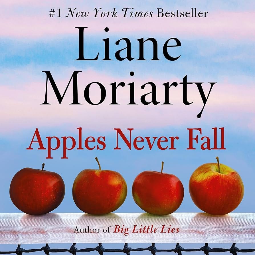 The cover of Apples Never Fall by Liane Moriarty has the title text laid out above a photograph of four red apples in a row.
