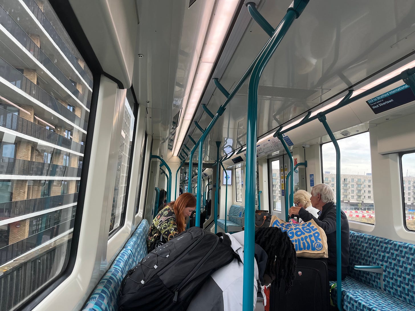 Photo of train interior passing alongside apartment buildings.