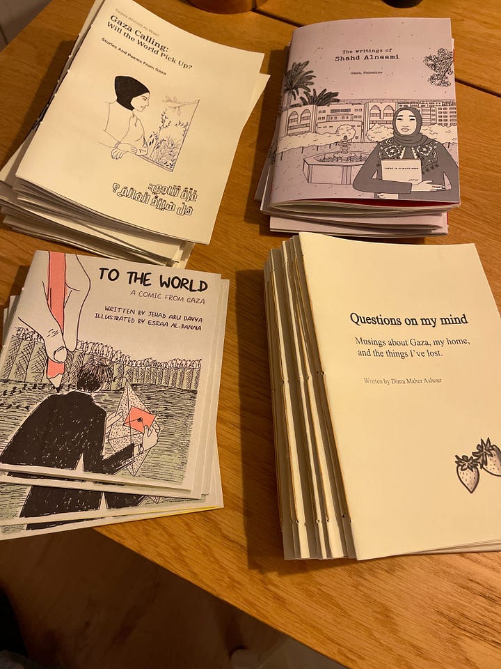 Four stacks of zines with illustrated covers on work table.