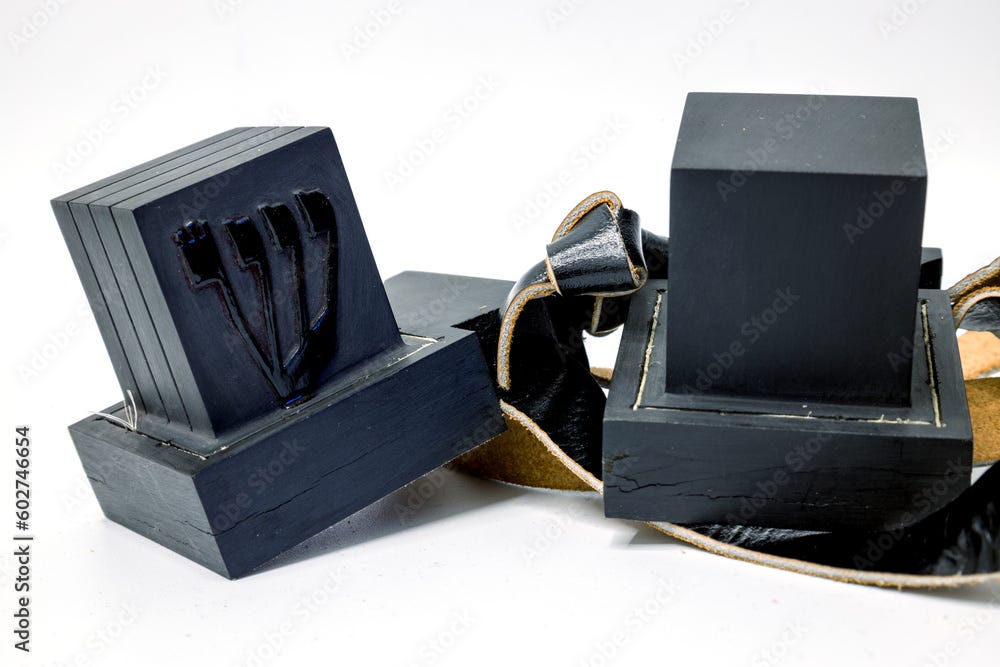 Tefillin or phylacteries . Pair of black leather boxes for the arm and ...