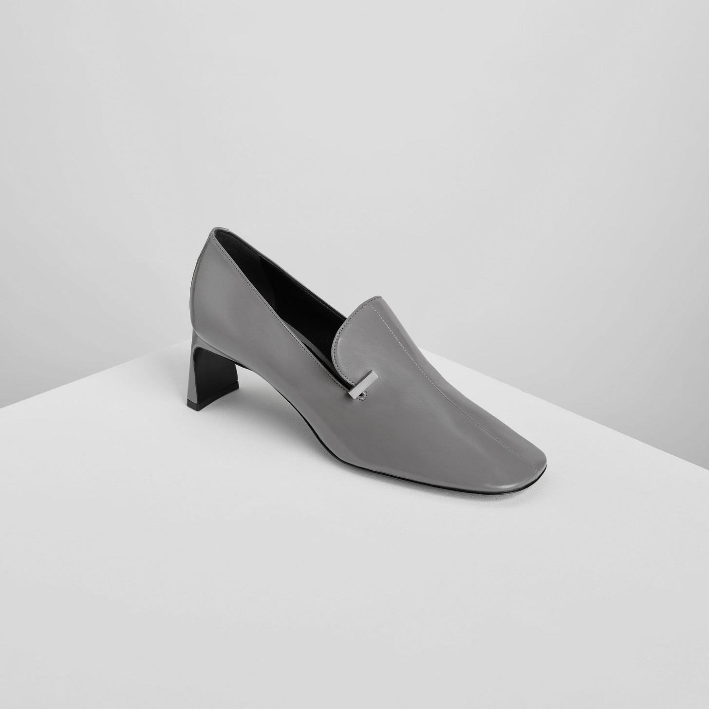 Angled front view of club loafers in cement leather.