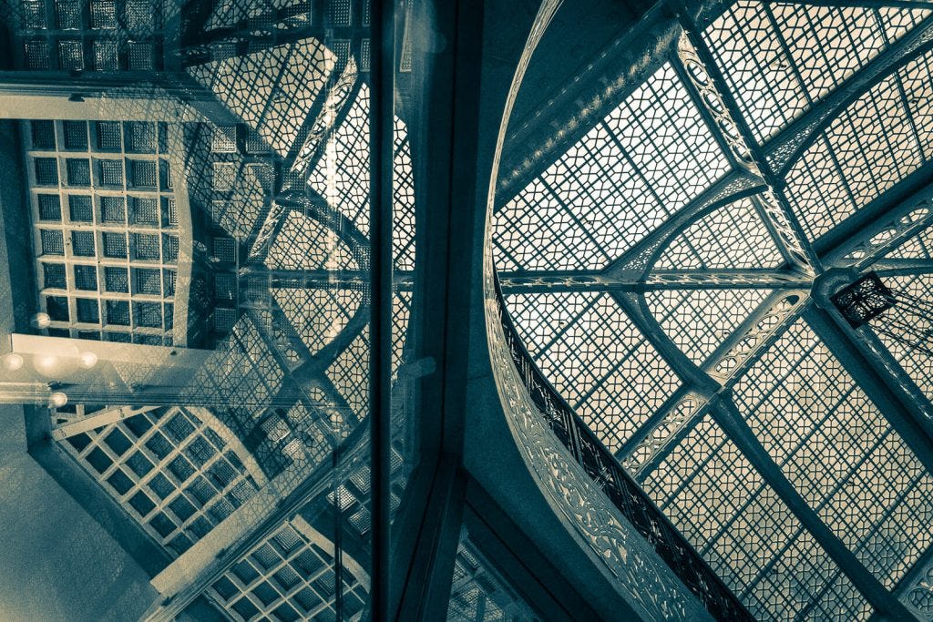 reflections in a glass railing