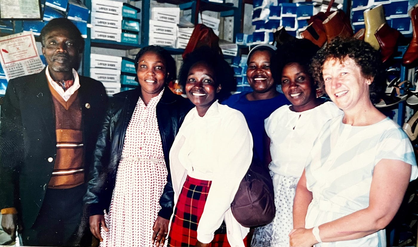 Black Kenyan women and one mane smile for the camera next to my White mother who is beaming