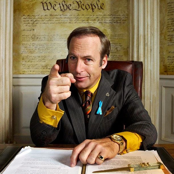 This may contain: a man in a suit pointing at the camera This may contain: a man in a suit pointing at the camera