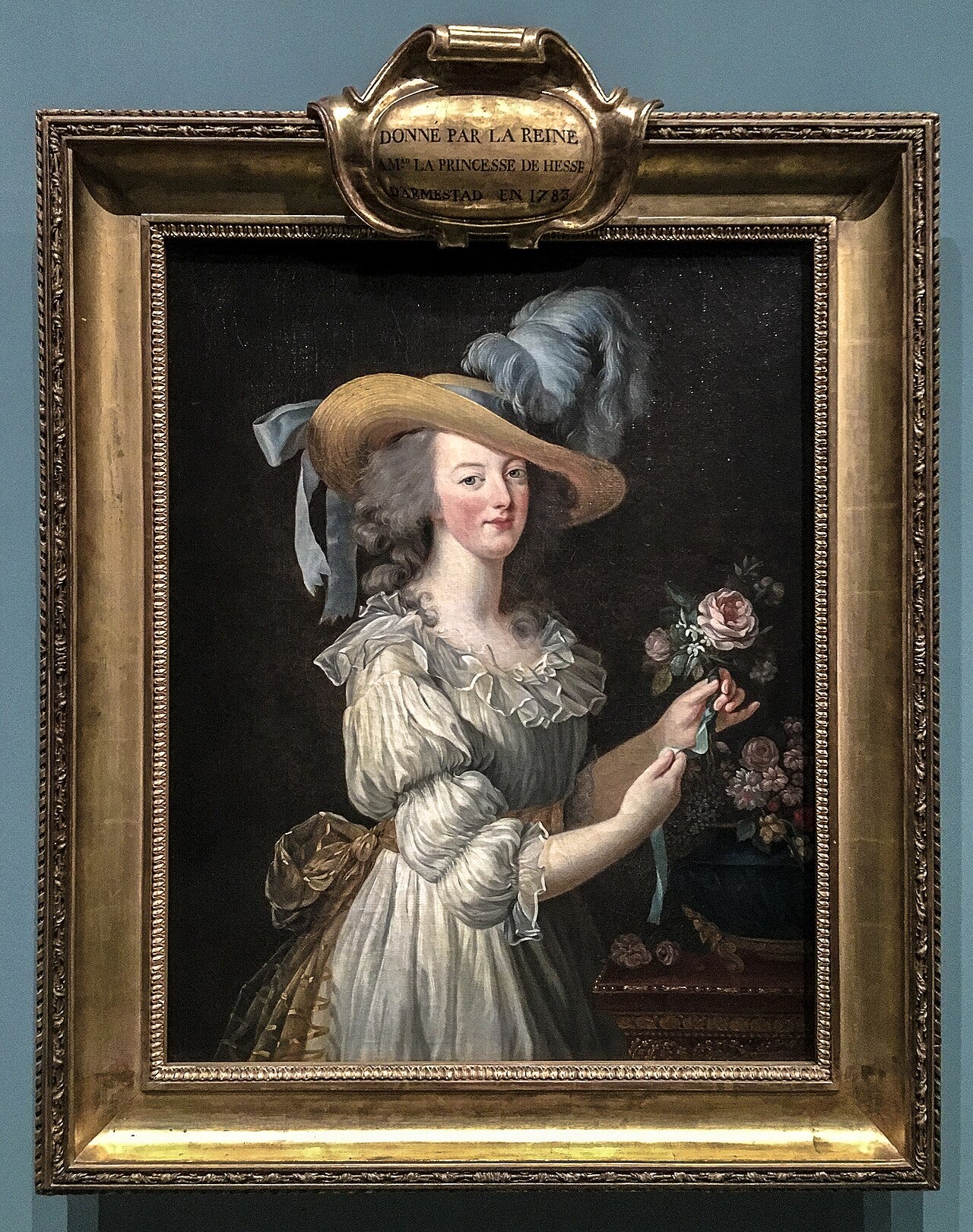 Marie Antoinette wearing a loose white muslin dress and straw hat, holding a flower Marie Antoinette wearing a loose white muslin dress and straw hat, holding a flower
