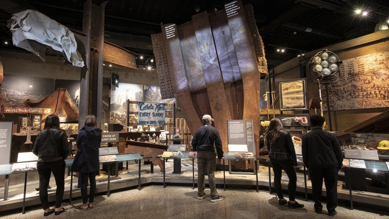 September 11, 2001: Visitors look at artifacts in the Museum's Historical Exhibition, including a large steel trident from a facade of the Twin Towers.