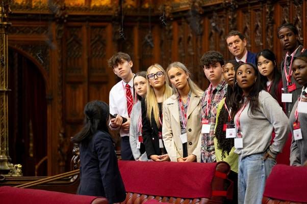 A group of people standing in a room
AI-generated content may be incorrect. A group of people standing in a room
AI-generated content may be incorrect.