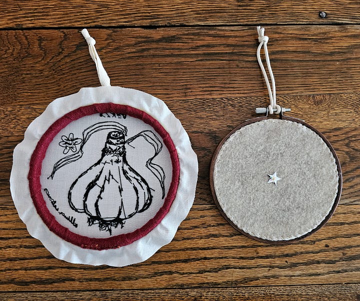 the backs of two embroideries, one left "open" and the other "finished" with felt