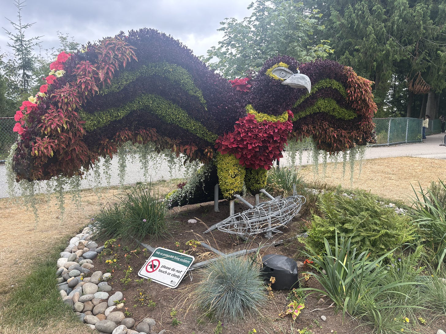 An eagle sculture made of flowers is colorful and stands out in a park