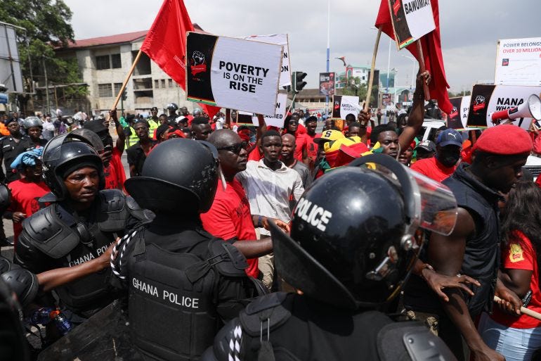 Police officers stand guard as protesters march during a demonstration on the current Cedi currency depreciation in the history of the country, a hike in fuel prices, and the general economic hardship, and asking Ghana President Nana Akufo-Addo and his deputy Mahamudu Bawumia to resign, in Accra, Ghana, on November 5, 2022. (Photo by Nipah Dennis / AFP) Police officers stand guard as protesters march during a demonstration on the current Cedi currency depreciation in the history of the country, a hike in fuel prices, and the general economic hardship, and asking Ghana President Nana Akufo-Addo and his deputy Mahamudu Bawumia to resign, in Accra, Ghana, on November 5, 2022. (Photo by Nipah Dennis / AFP)