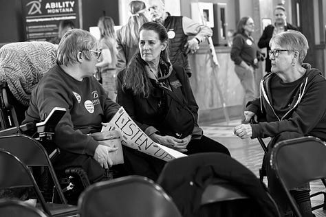 A gallery of black and white photos of a rally in the rotunda of Montana's state capitol. people are holding signs in support of disability rights, there is a podium with legislators speaking, people with a virety of physical disabilities are throughout the crowd.