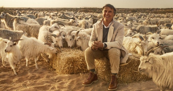 Brunello Cucinelli among cashmere goats in Mongolia, as seen in the documentary 'Brunello: The Gracious Visionary.'