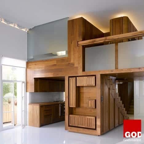 Hogarth Architects transformed another large one-room flat in London into a stylish apartment using a wood insert that creates a separated kitchen and loft. It’s essentially one big piece of furniture custom-made for the space.