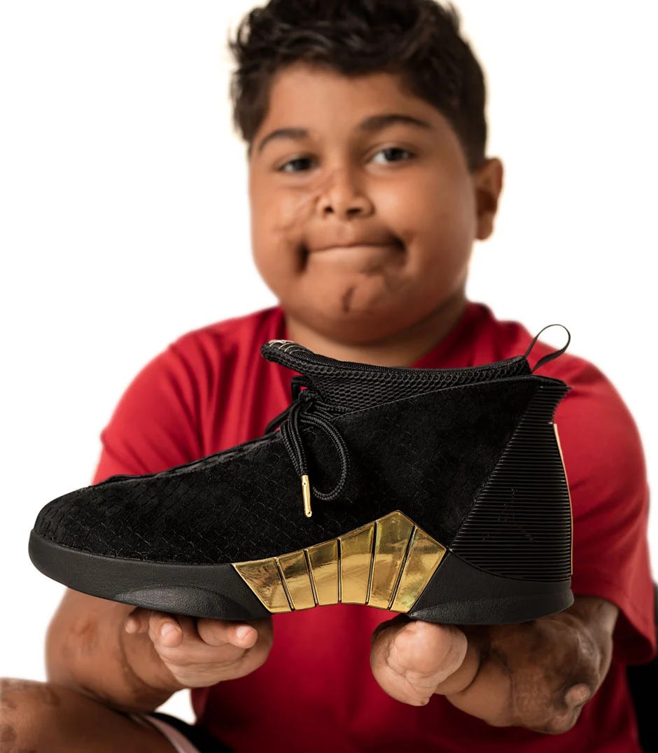 Donovon Dinneen holding up his Air Jordan 15 Doernbecher design. via Nike Donovon Dinneen holding up his Air Jordan 15 Doernbecher design. via Nike