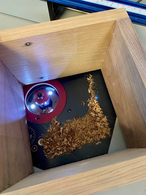 Using a mortising bit to cut a groove for the base to sit into.