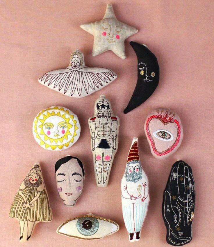 This may contain: several decorative items are arranged on a pink surface