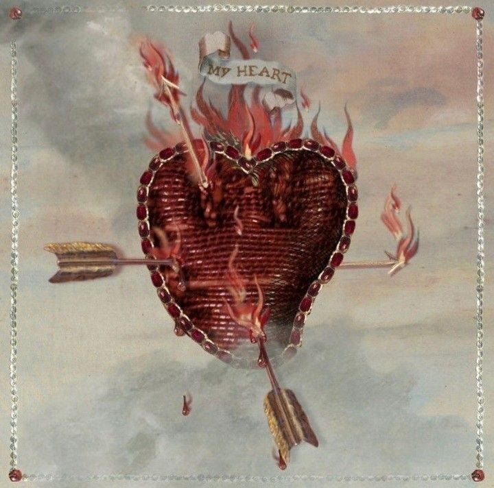 This may contain: a heart with an arrow and some fire on it This may contain: a heart with an arrow and some fire on it