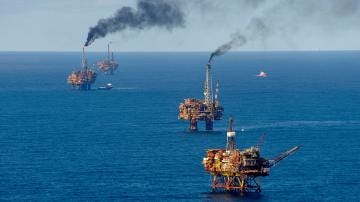 Aerial view of oil platforms in the North Sea. Aerial view of oil platforms in the North Sea.