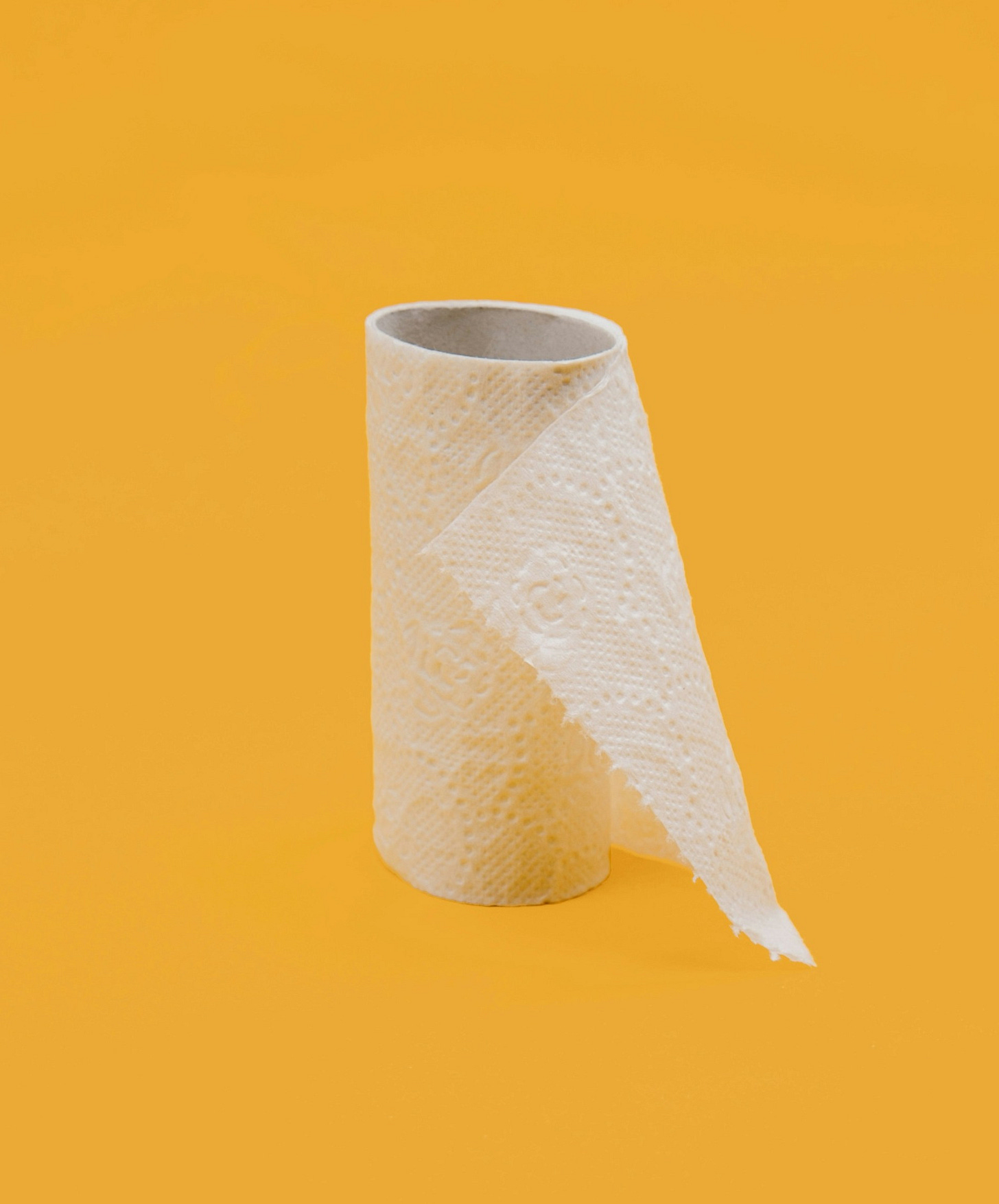 paper towel role on yellow background
