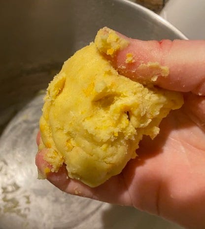 hand holding ball of cookie dough