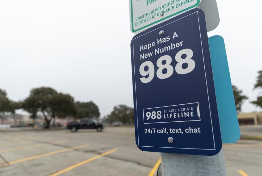 A sign for the national suicide and crisis hotline number, 988, is posted at a North Austin parking lot, on Friday, Jan. 3, 2025. A sign for the national suicide and crisis hotline number, 988, is posted at a North Austin parking lot, on Friday, Jan. 3, 2025.