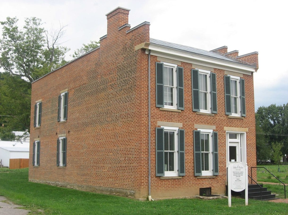 A brick building with a sign

Description automatically generated