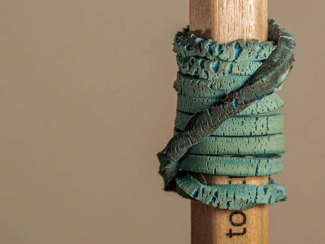 a close up of a wooden stick with a string wrapped around it a close up of a wooden stick with a string wrapped around it
