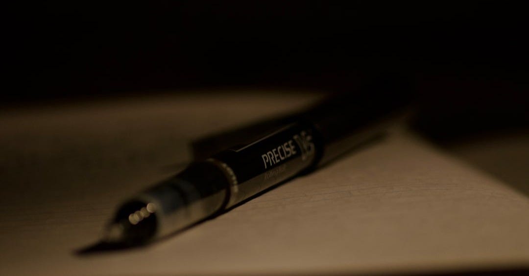 A close-up of a pen resting on paper.