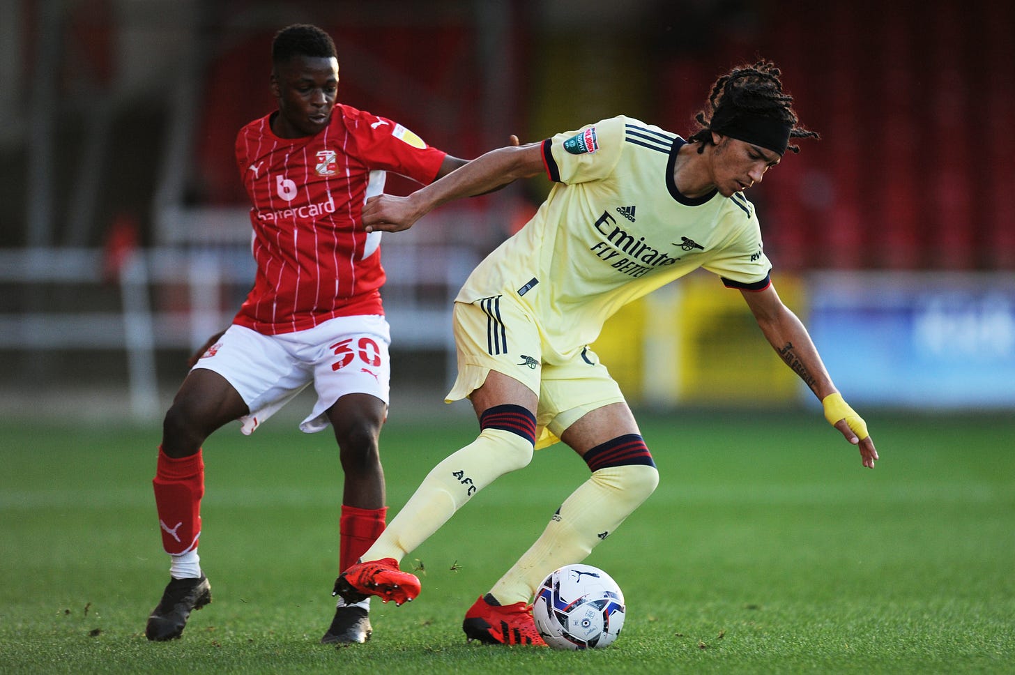 Kido Taylor-Hart pictured (right) playing for Arsenal U21 against Swindon Town in the EFL Trophy in September 2021 Kido Taylor-Hart pictured (right) playing for Arsenal U21 against Swindon Town in the EFL Trophy in September 2021