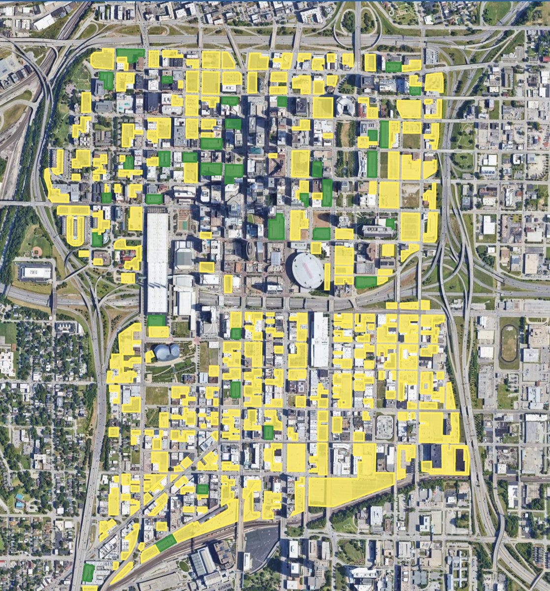 Aerial google earth image with yellow showing surface lots and green showing garages. 